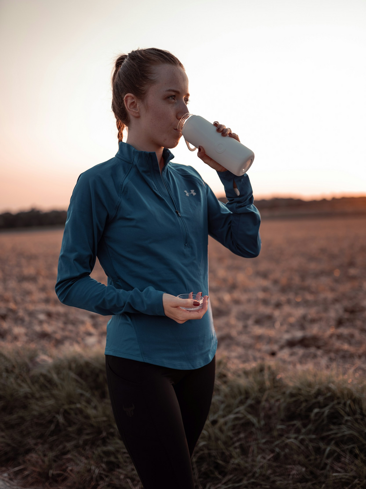 A collection of gym and sport water bottles in various colors and designs, showcasing sleek stainless steel, insulated, and leak-proof bottles arranged with a neutral background and subtle fitness elements, emphasizing hydration and active lifestyles.